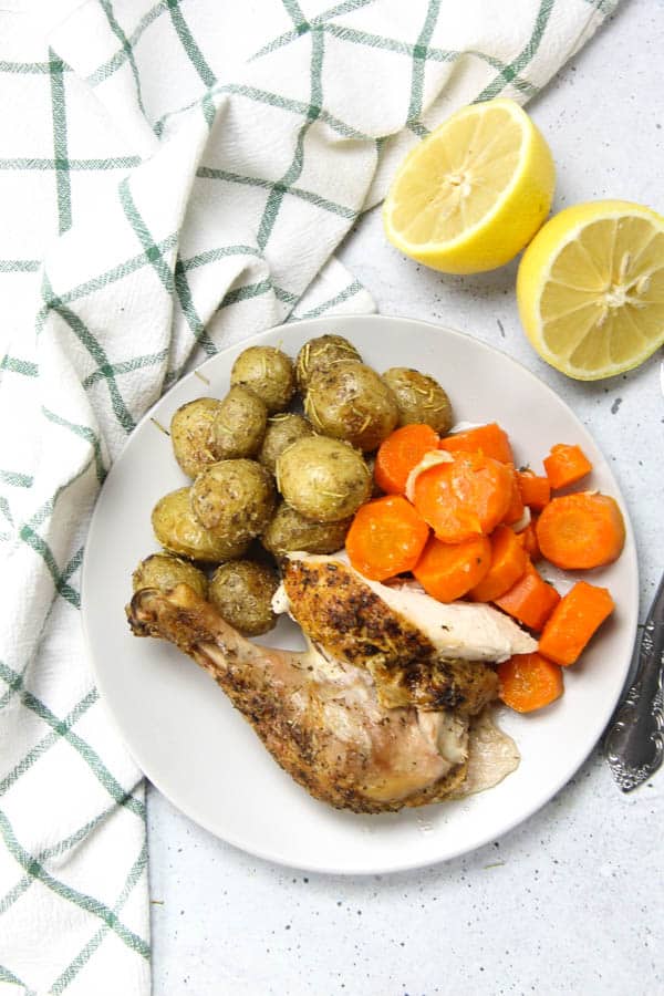 This Oven Baked Whole Chicken is cooked up perfectly with lemon, garlic and herbs. Tender, moist and lemony chicken for dinner!