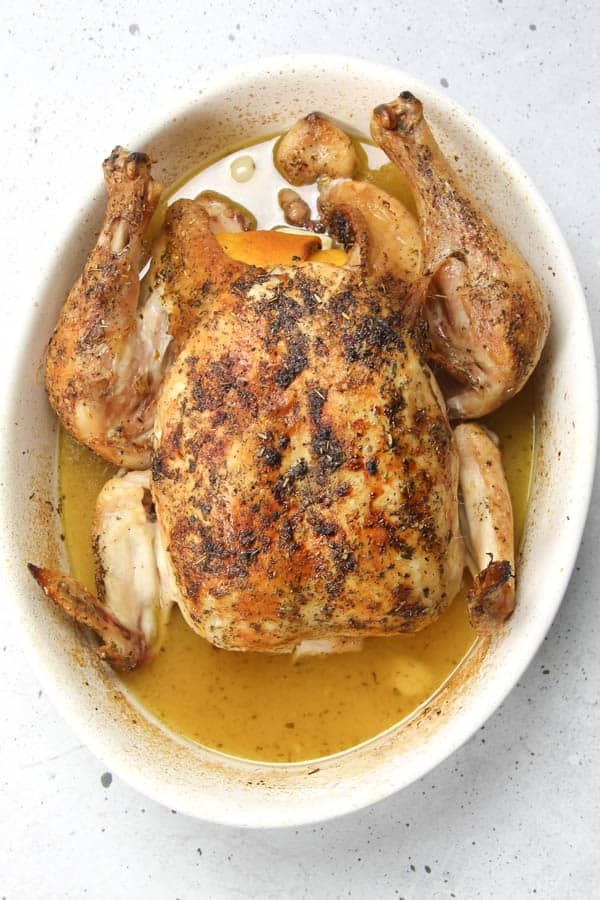 This Oven Baked Whole Chicken is cooked up perfectly with lemon, garlic and herbs. Tender, moist and lemony chicken for dinner!