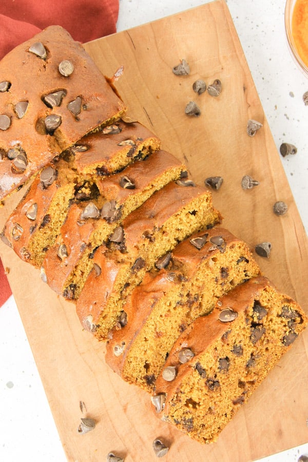 Delicious and easy Chocolate Chip Pumpkin Bread! Moist and tender, this bread is filled with warm spices and rich chocolate! Chocolate Chip Pumpkin Bread on cutting board