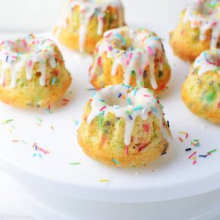 Funfetti Mini Bundt Cakes with 6 cakes on white cake plate