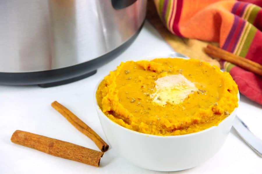 Easy Instant Pot Mashed Sweet Potatoes with Cinnamon! Creamy potatoes flavored with cinnamon, nutmeg and butter! The BEST side dish! Instant Pot Mashed Sweet Potatoes with Cinnamon in white bowl