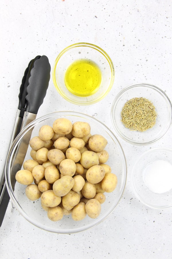 Roasted Rosemary Potatoes bakes up quick and easy! Creamy potatoes loaded with rosemary, for the best side dish! Roasted Rosemary Potatoes Ingredients in glass bowls
