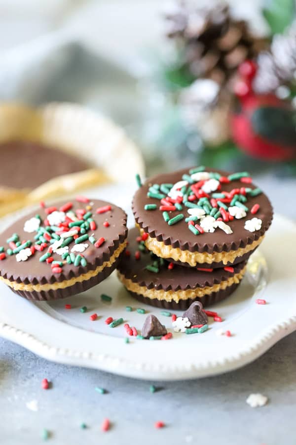 Easy Homemade Peanut Butter Cups! Layers of rich chocolate and creamy peanut butter, these are a fantastic treat! Perfect for freezing too! Homemade Peanut Butter Cups with sprinkles on white plate