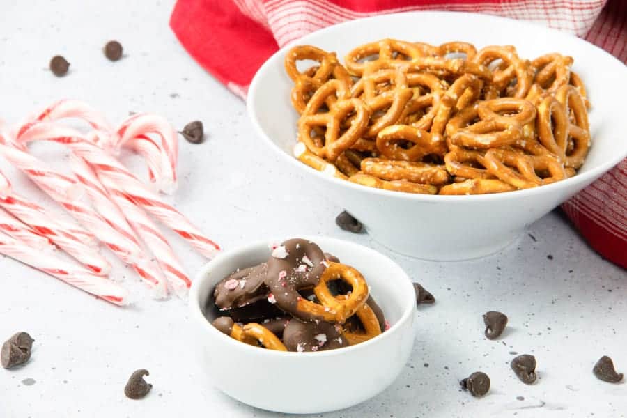 These Peppermint Chocolate Dipped Pretzels are an easy last minute treat! A delicious sweet and salty snack! Chocolate dipped pretzels in white bowl