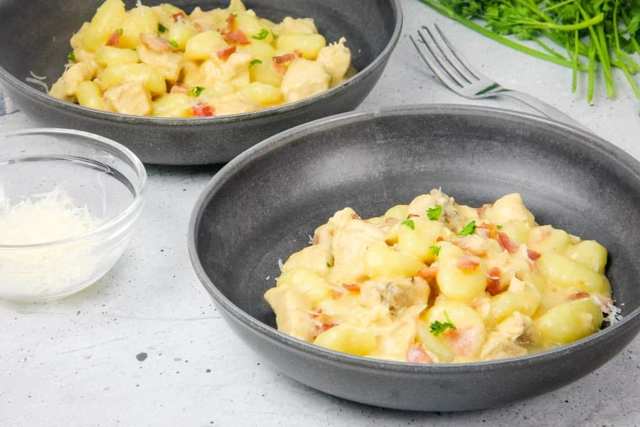 This Chicken Bacon Gnocchi Skillet is a delicious one pot meal! With tender chicken, gnocchi and crispy bacon, it makes a complete meal! Chicken Bacon Gnocchi Skillet in bowls