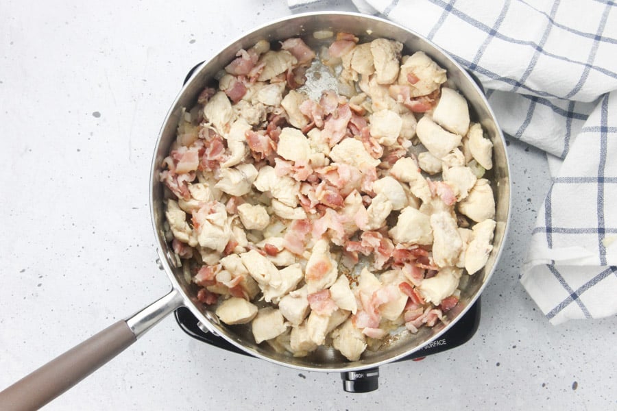 Chicken and bacon cooked in skillet
