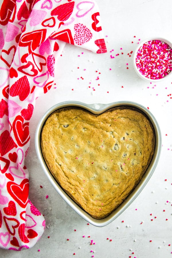 This easy, rich, and chewy Dark Chocolate Cookie Cake is the perfect treat for Valentine's Day! Bakes up in 15 minutes! Dark Chocolate Cookie Cake in heart shaped pan