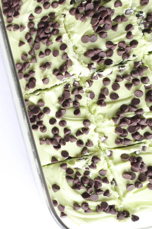 Mint Chocolate Chip Brownies are fudgy and decadent dessert. Topped with a semi-homemade frosting, with lots of mint flavor! Mint Chocolate Chip Brownies cut into pieces in dish.