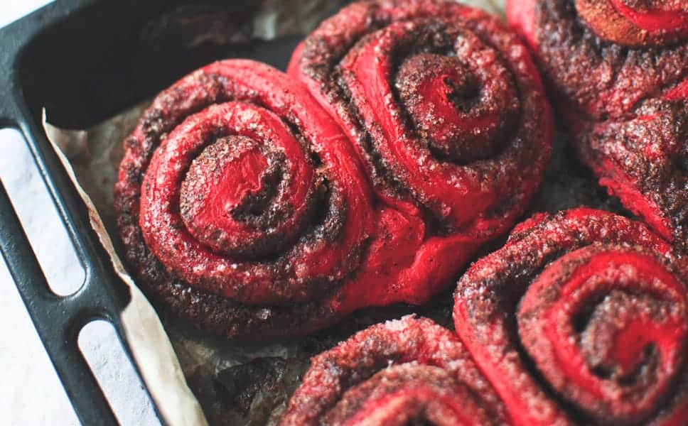 These Red Velvet Cinnamon Rolls are such a fun treat for breakfast or brunch! Made with a homemade dough and topped with a gooey frosting! Red Velvet Cinnamon Rolls in pan