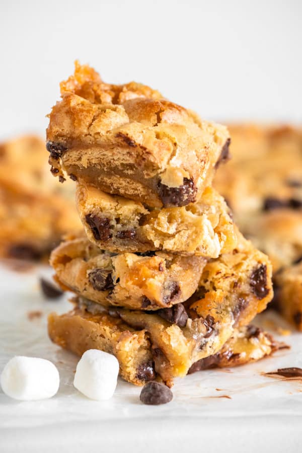 Easy S'mores Blondies are full of your favorite summertime flavors wrapped up in one bar! Perfect all year round! S'mores Blondies stacked on top of each other.