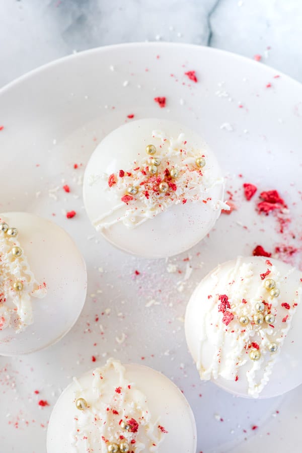 These Strawberry Hot Cocoa Bombs are the perfect sweet treat! So fun for Valentine's day or any day of the week bombs on plate