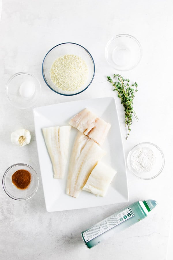 Air Fryer Fish Nuggets are crispy on the outside and cooked perfectly on the inside! Made with cod, panko and herbs. ingredients for air fryer fish nuggets on plate.