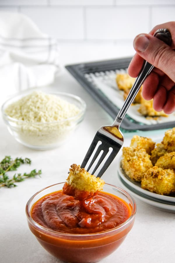 Air Fryer Fish Nuggets are crispy on the outside and cooked perfectly on the inside! Made with cod, panko and herbs. Dipping nuggets into cocktail sauce.