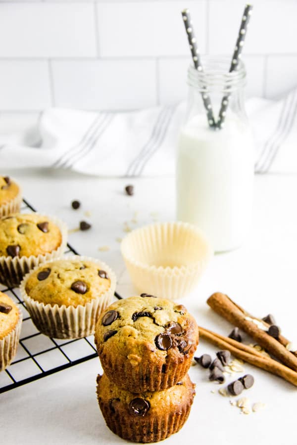 These Chocolate Chip Oatmeal Cookies are delicious for a grab and go breakfast! Made with oats, chocolate chips and a touch of cinnamon! two muffins without liners stacked.