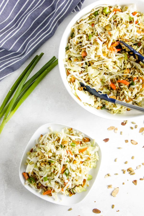 This easy Ramen Salad is a delicious side dish full of toasted almonds, sunflower seeds and topped with a tasty vinegar dressing! Easy Ramen Salad on plate and in bowl.