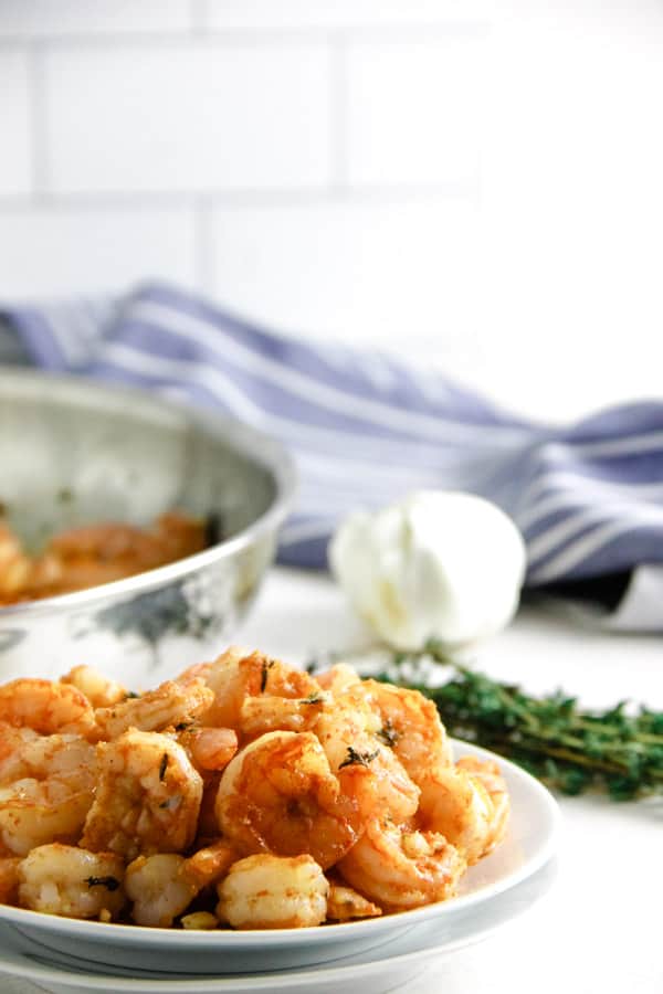 Quick and easy Spicy Garlic Thyme Shrimp! Loads of flavor and made with just 6 ingredients! Spicy Garlic Thyme Shrimp on white plate.