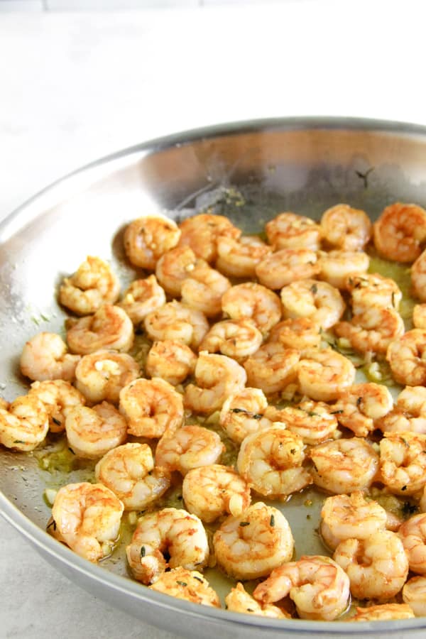 Quick and easy Spicy Garlic Thyme Shrimp! Loads of flavor and made with just 6 ingredients! Spicy Garlic Thyme Shrimp cooked in pan.