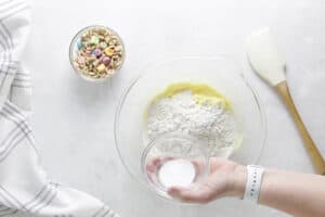 adding baking soda to glass bowl.