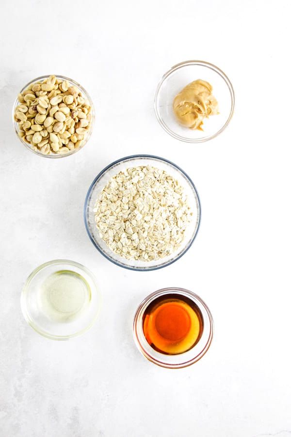 This easy Peanut Butter Granola snack is so delicious, you will be making it over and over again! Packed with peanut butter flavor! peanut butter granola ingredients in bowls.