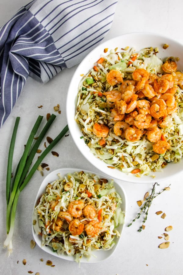 Delicious, but simple Shrimp Ramen Salad! With spicy shrimp, toasted almonds, sunflower seeds and a shrimp flavored dressing! overhead view of Shrimp Ramen Salad.