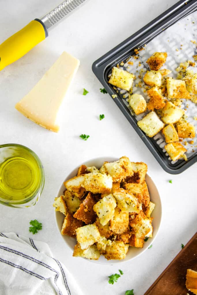 These Air Fryer Croutons are the perfect addition to salads or soups! Made with breads, spices and freshly grated Parmesan cheese! overhead view of croutons in bowl.