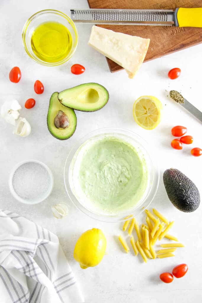 This Creamy Avocado Pasta is silky, fresh, and easy to prep! Use a ripe avocado, fresh tomatoes top it over your favorite pasta noodle! Ready in less than 30 minutes, make for an easy week night meal! ingredient in bowls.