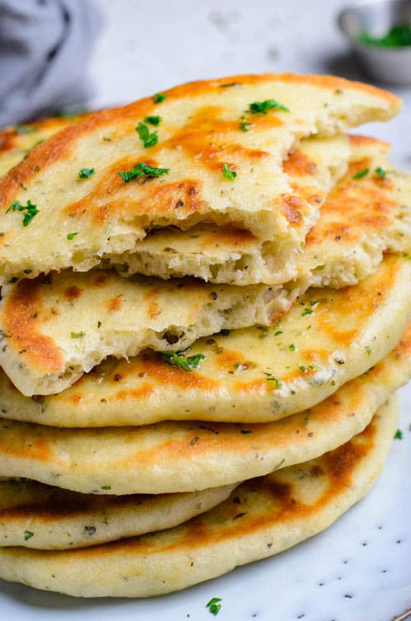 Easy Homemade Flatbread will be the only flatbread you will ever need! torn pieces of flatbread stacked.