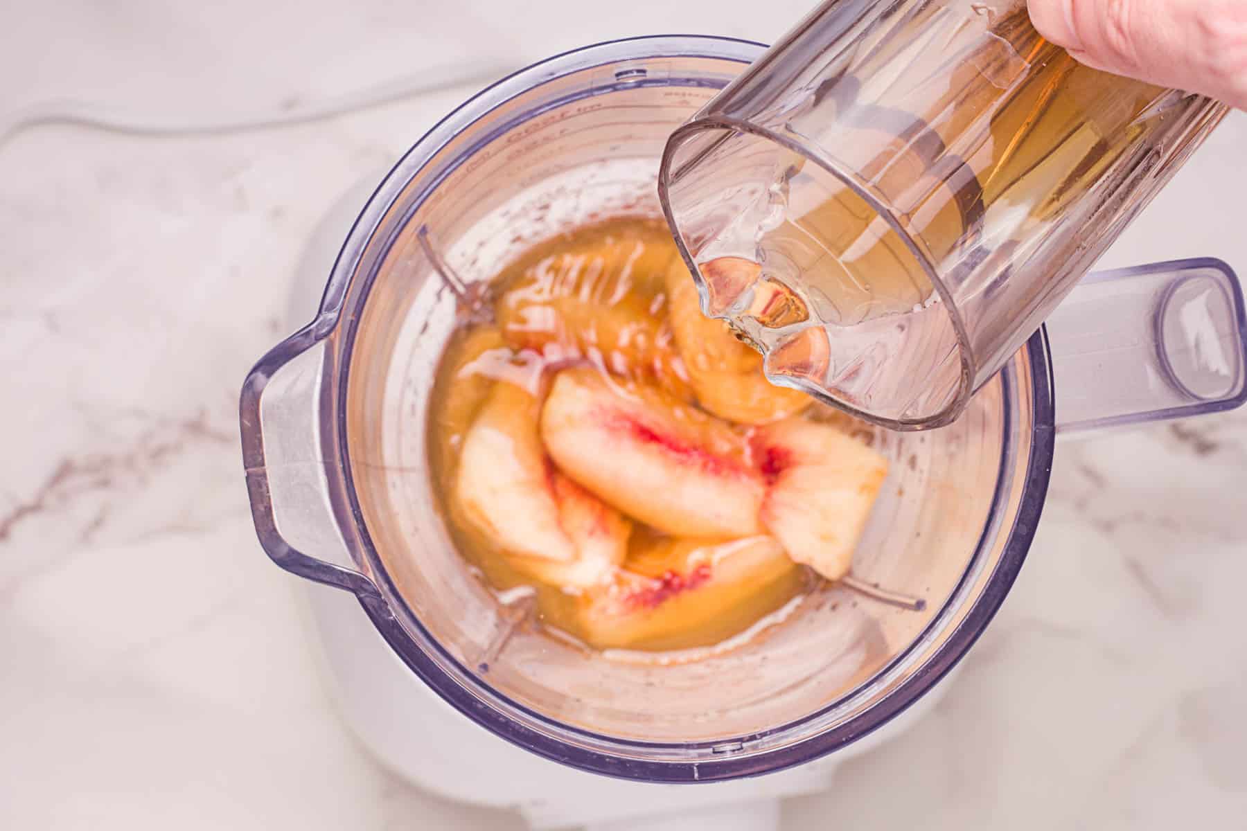 adding in brewed tea to mixer.
