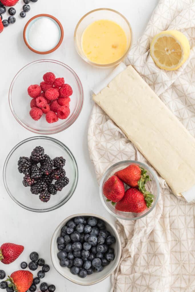 Mixed Berry Turnovers can brighten up your breakfast or your dessert. They are ready in less than half an hour, too! Use any kind of fresh berry you want! mixed berry turnover ingredients in bowls.