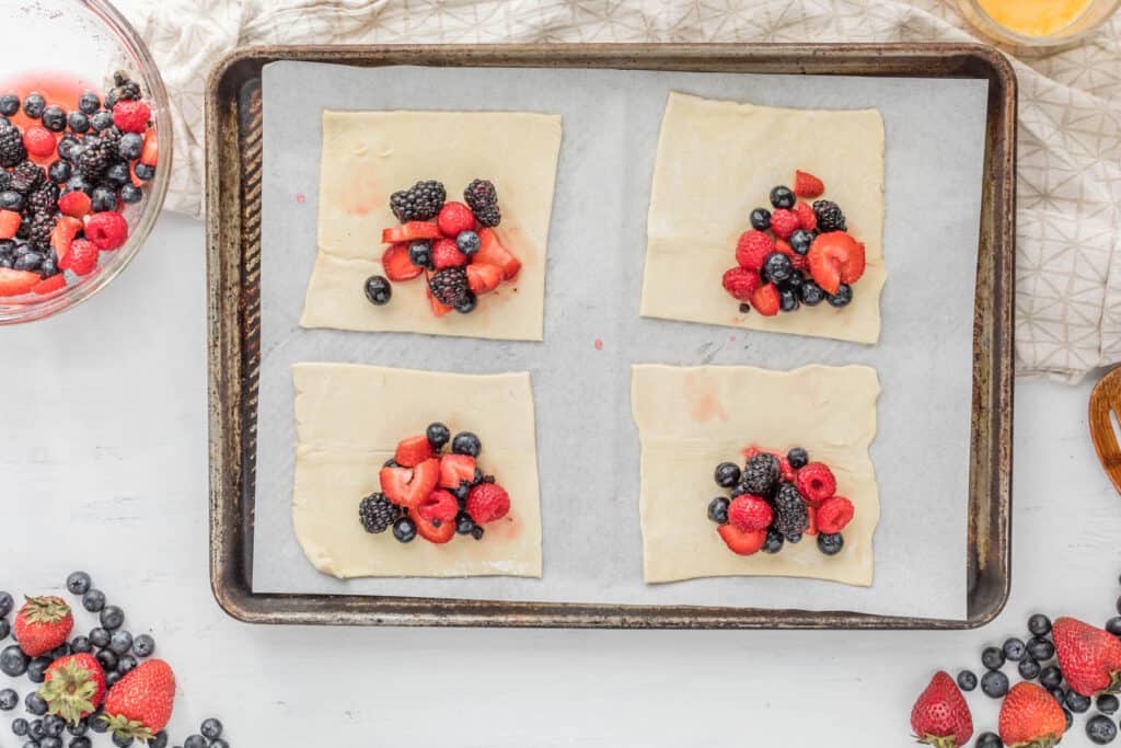 berries on puff pastry on tray.