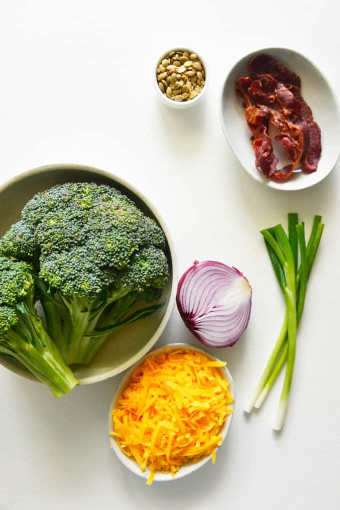 This Easy Broccoli Salad is made with bacon, cheddar cheese and a creamy mayonnaise sauce! Easy Broccoli Salad ingredients on white background.