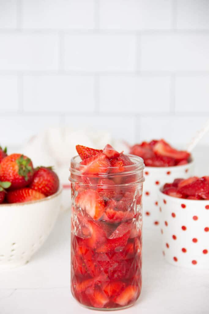 This Easy Strawberry Sauce Recipe is made with just two ingredients and there is no cooking involved! Perfect on cake, ice cream, or granola! Easy Strawberry Sauce Recipe in glass jar.