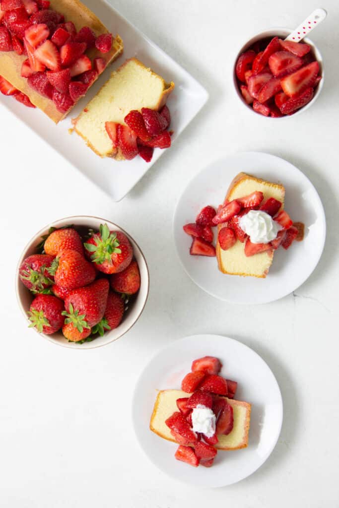 This Easy Strawberry Sauce Recipe is made with just two ingredients and there is no cooking involved! Perfect on cake, ice cream, or granola! Easy Strawberry Sauce Recipe on pound cake on white plates.