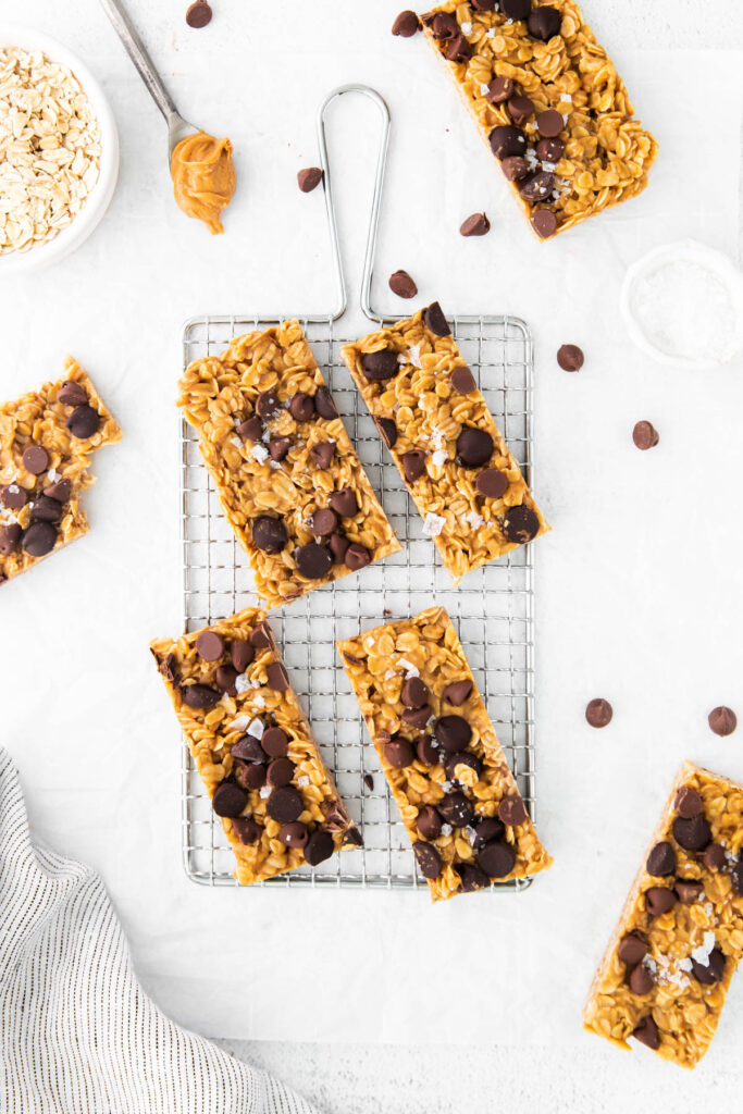 Chewy Oatmeal Granola Bars are made in just about 10 minutes! Filled with peanut butter, oats, honey, and any kind of chocolate chip! Chewy Oatmeal Granola Bars overhead view on tray.