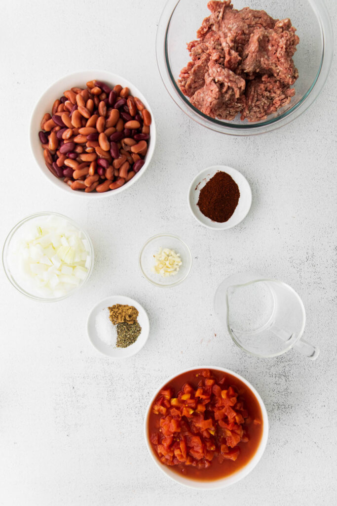 Easy Slow Cooker Chili with homemade seasoning and robust flavor! Packed with protein and perfect for a weeknight dinner! Slow Cooker Chili ingredients in bowls.