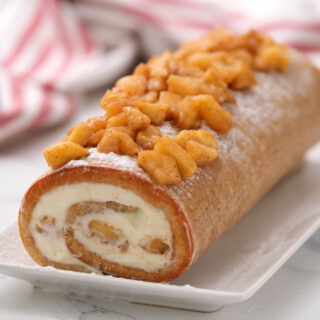 Cinnamon Apple Cake Roll on white plate.