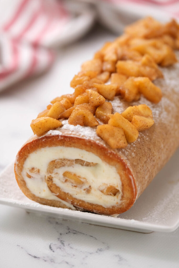 Easy Cinnamon Apple Cake Roll made with fresh apples, cinnamon and cream cheese icing. A flavorful cake with a creamy filling!