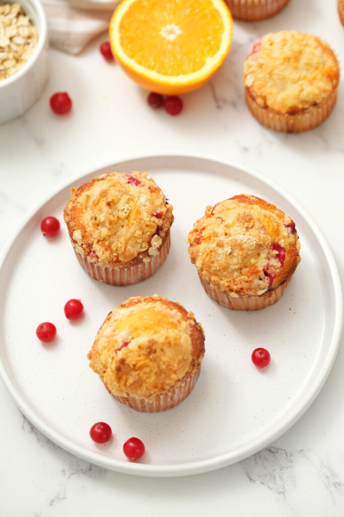 These Cranberry Orange Muffins are moist and flavorful! topped with a buttery crumb topping! Just like a bakery! overhead view of cranberry orange muffins.