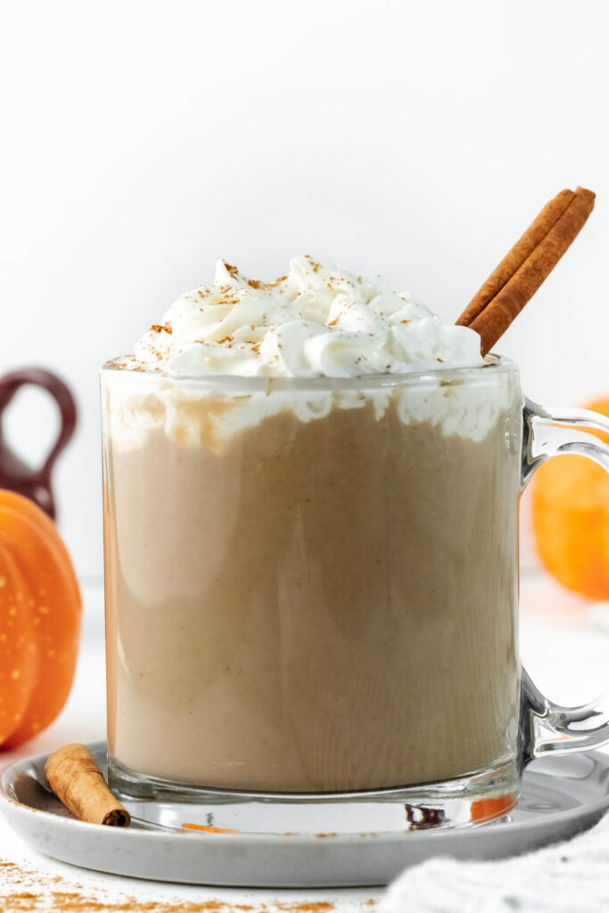 This Pumpkin Spice Latte taste just like the big chains! You can easily make it at home for the same great taste! Pumpkin Spice Latte in glass cup.