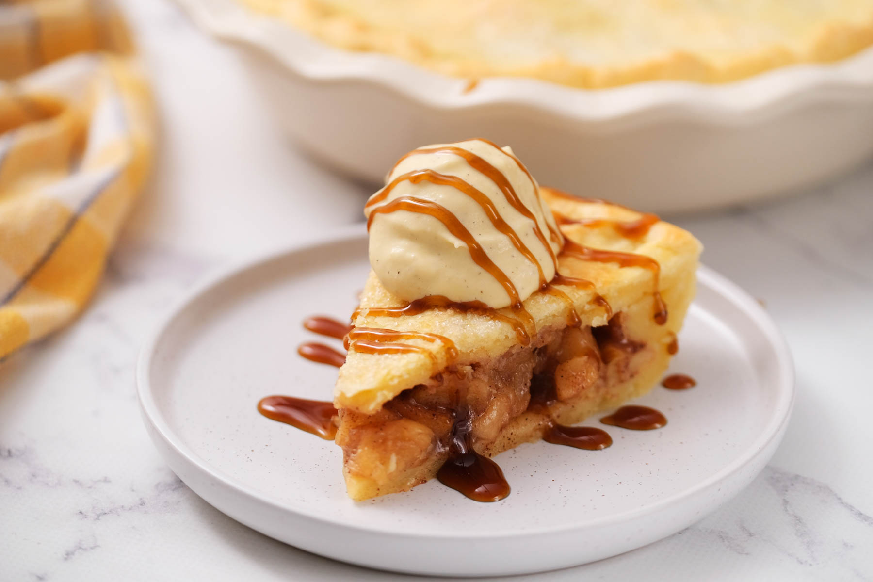 This Simple Apple Pie will get you warm, delicious pie in just about 30 minutes! Filled with soft apples, cinnamon and brown sugar. slice of pie drizzled with caramel sauce.