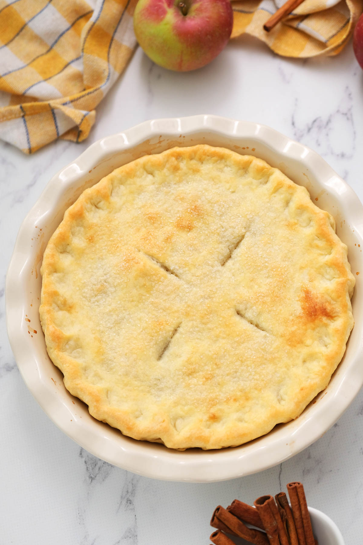 This Simple Apple Pie will get you warm, delicious pie in just about 30 minutes! Filled with soft apples, cinnamon and brown sugar. overhead of whole pie in pie plate.