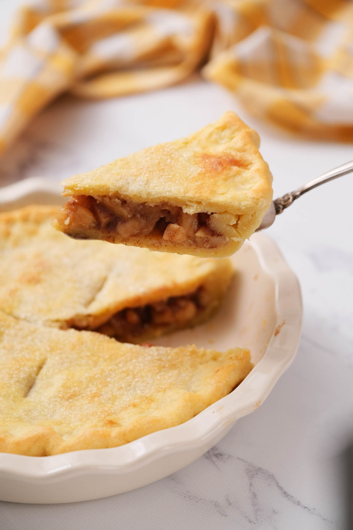 This Simple Apple Pie will get you warm, delicious pie in just about 30 minutes! Filled with soft apples, cinnamon and brown sugar. slice of pie on serving utensil.