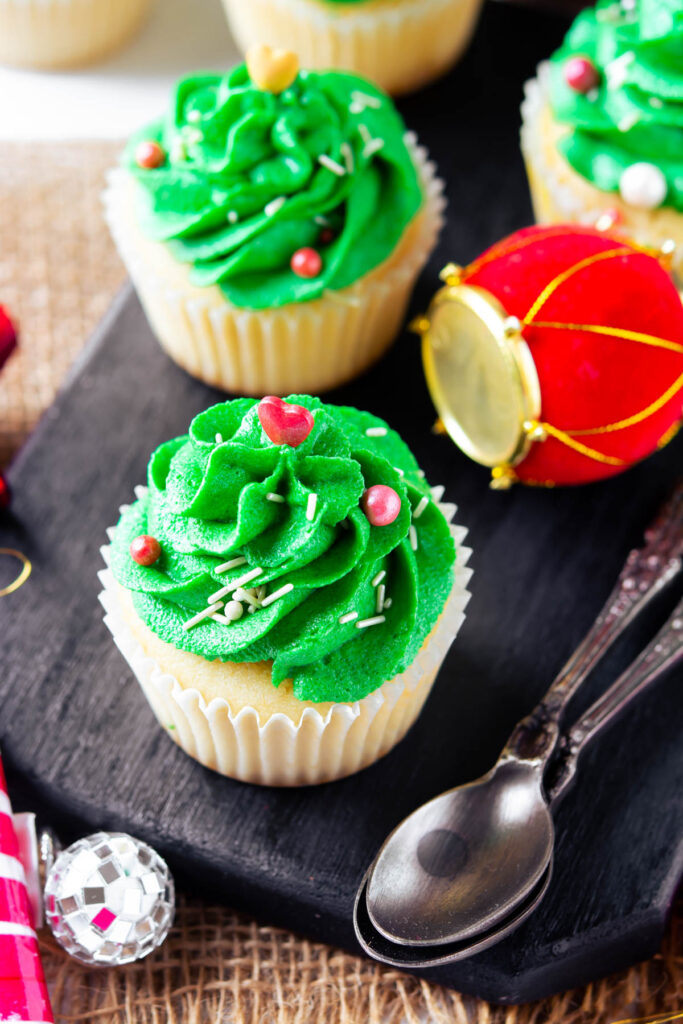 Homemade Christmas Tree Cupcakes that are moist and fluffy! Topped with a festive buttercream frosting! Christmas Tree Cupcakes on black background.