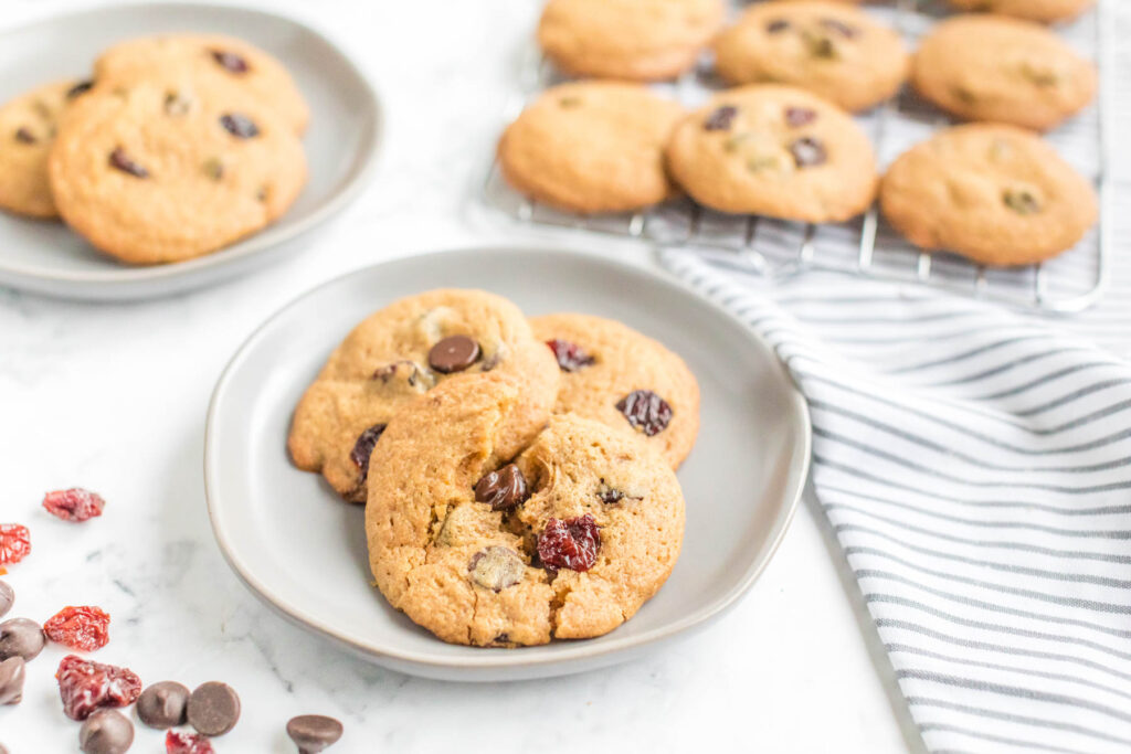 Soft, buttery Dark Chocolate Chip Cherry Cookies! Flavored with a touch of almond extract and lots of dark chocolate! Dark Chocolate Chip Cherry Cookies on plate.