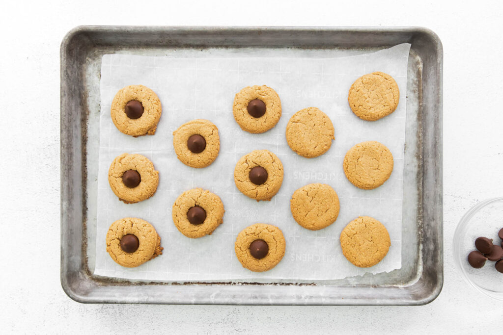 cookies topped with kisses on sheet pan.
