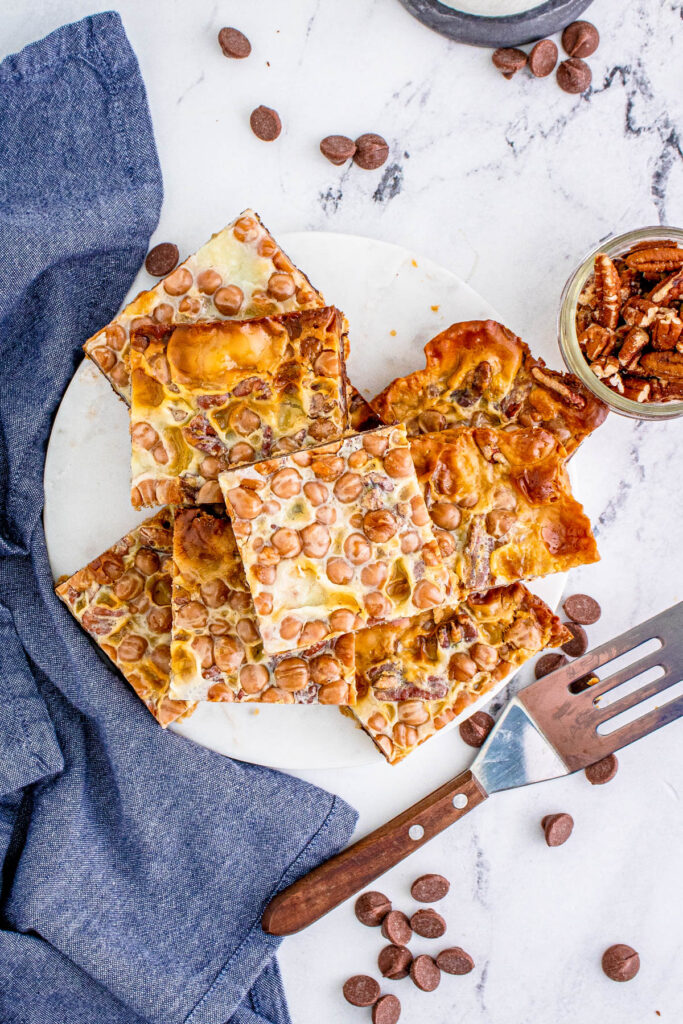These Turtle Magic Bars are a fun twist on a classic recipe! With rich layers and great flavor these bars are the perfect treat! overhead view of Turtle Magic Bars on plate.