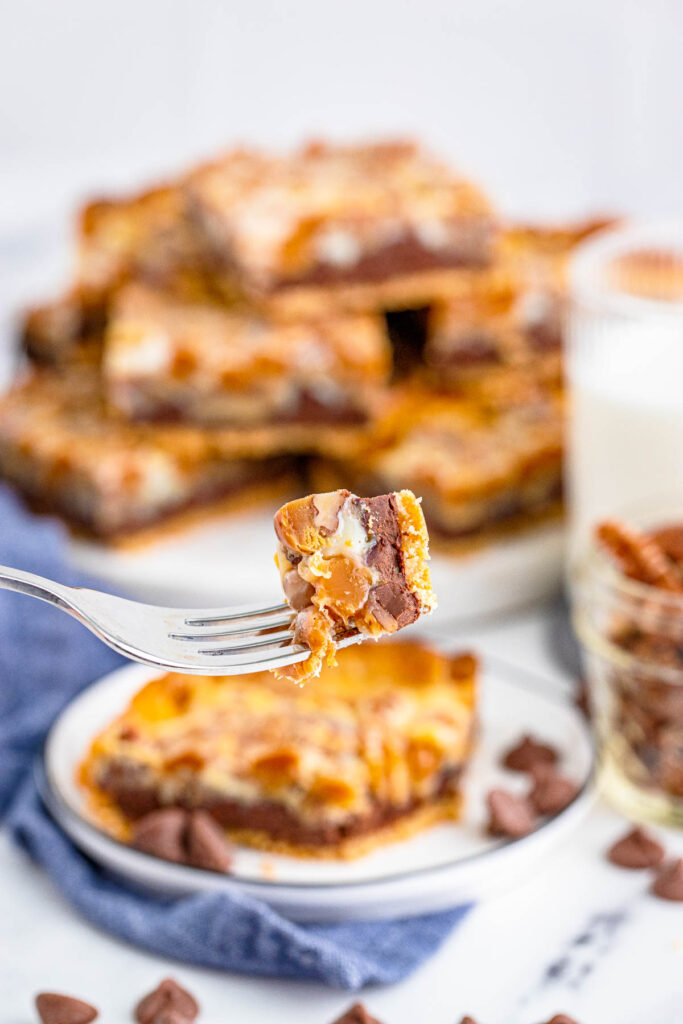 These Turtle Magic Bars are a fun twist on a classic recipe! With rich layers and great flavor these bars are the perfect treat! bite of Turtle Magic Bars on fork.