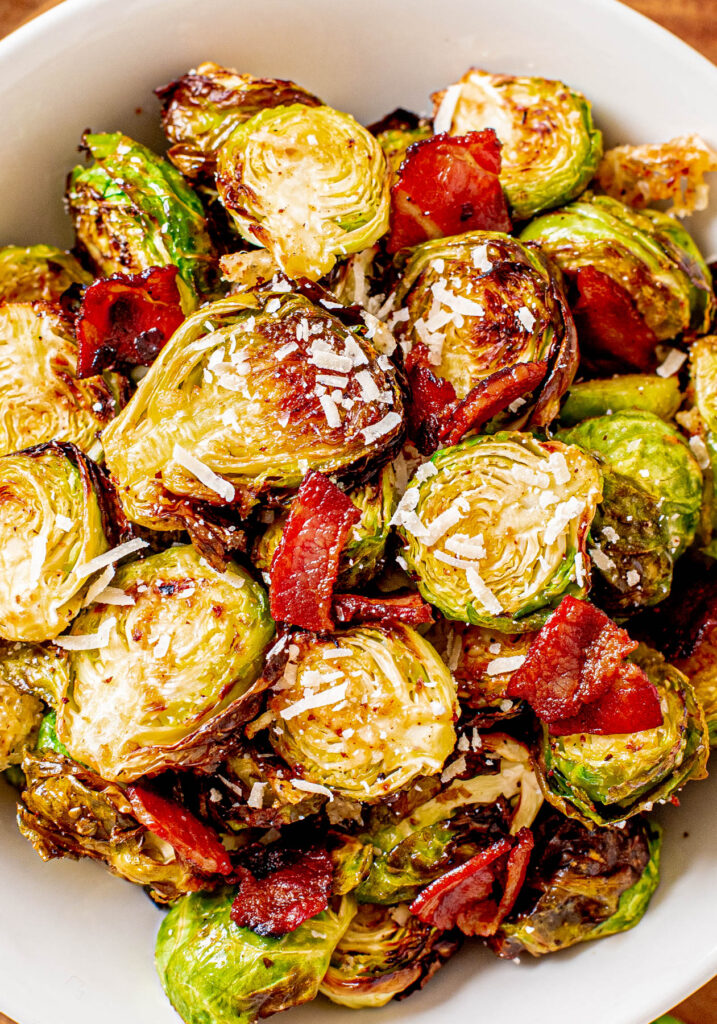 Air Fryer Brussels Sprouts are an easy side dish. Air Fryer Brussels Sprouts in white bowl with bacon.