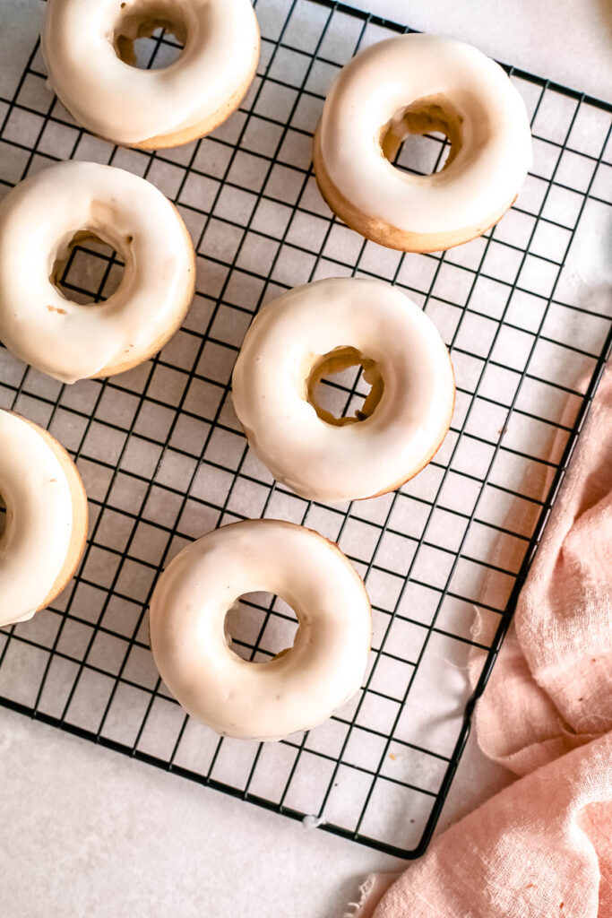 These Baked Lemon Donuts have a light and cake light texture that’s delicious and perfect to serve with a cup of coffee! Baked Lemon Donuts on wire cooling rack.