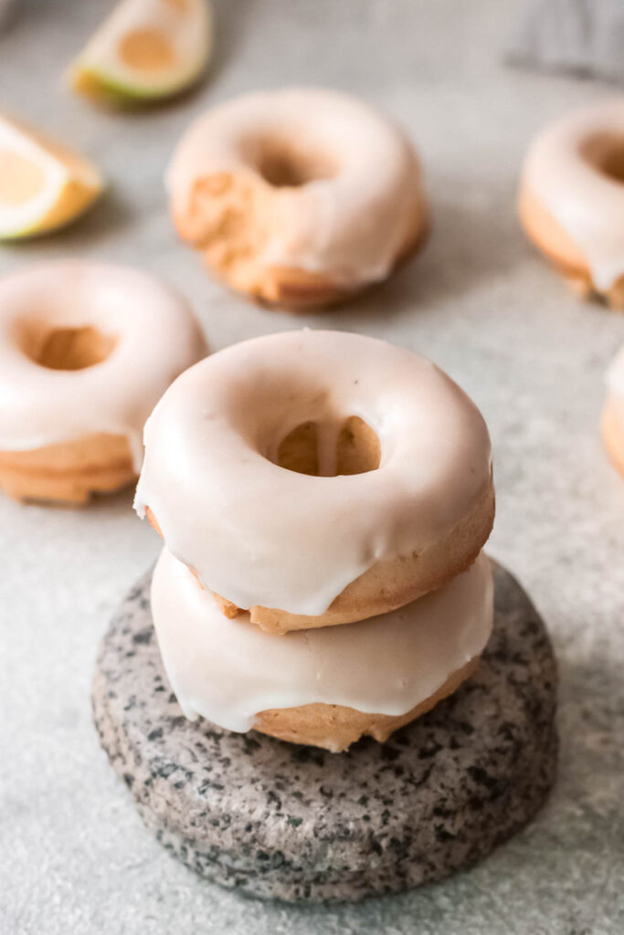 These Baked Lemon Donuts have a light and cake light texture that’s delicious and perfect to serve with a cup of coffee! Baked Lemon Donuts stacked.
